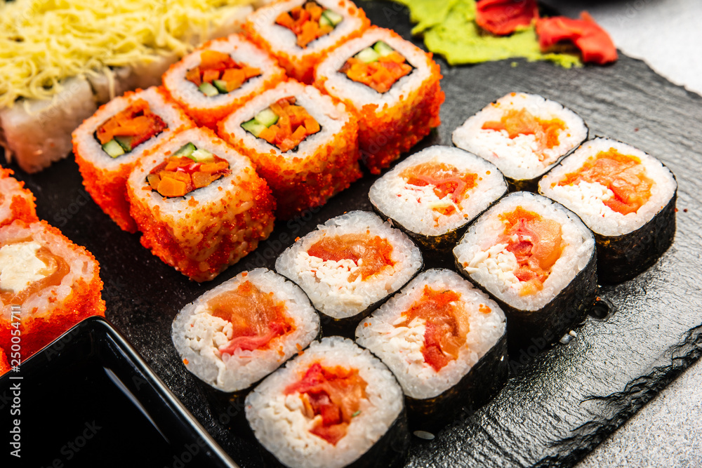 Big sushi set with variety of sushi rolls,on stylish dark background. Big sushi set with variety of sushi rolls,on stylish dark background.