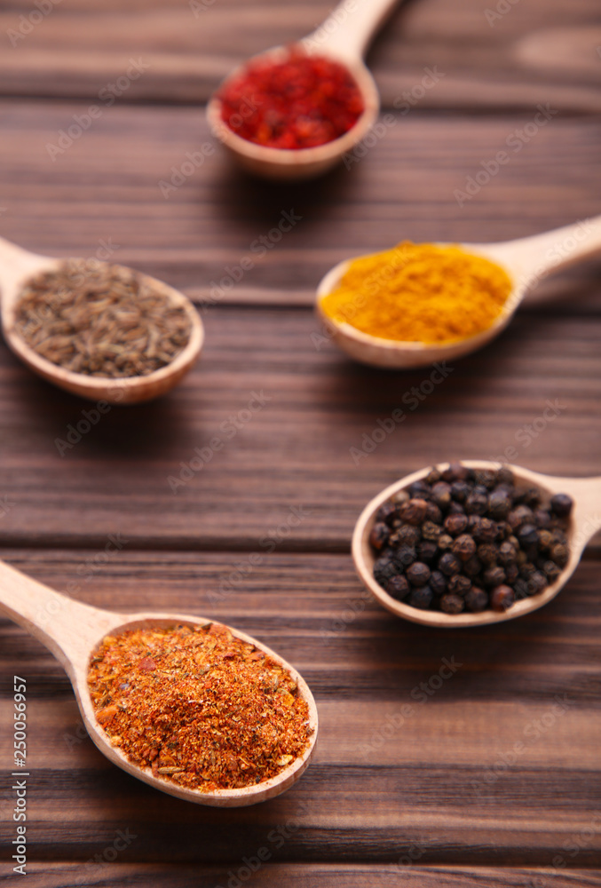 Spices mix on wooden spoons on a brown wooden background. Top view Spices mix on wooden spoons on a brown wooden background. Top view