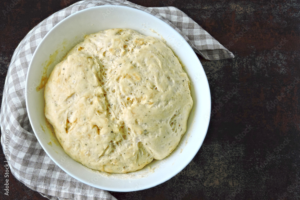 Raw yeast dough in a bowl. Soft and airy yeast dough. Raw yeast dough in a bowl. Soft and airy yeast dough.