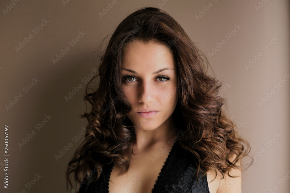 Beautiful brown-haired girl looking at camera at home Beautiful brown-haired girl looking at camera at home