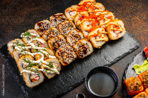 Big sushi set with variety of sushi rolls,on stylish dark background.