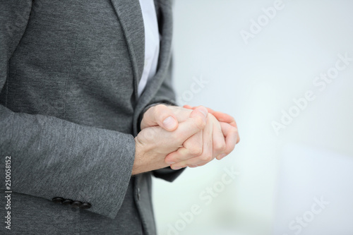 close up.thoughtful businessman folded his hands in front of him