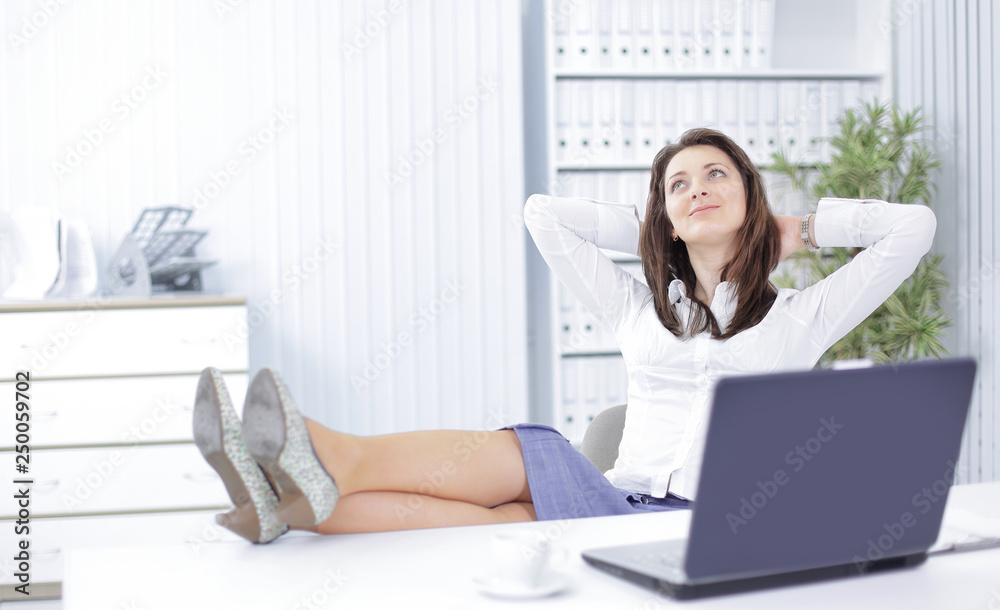 smiling employee in a work break ,sitting at the table smiling employee in a work break ,sitting at the table
