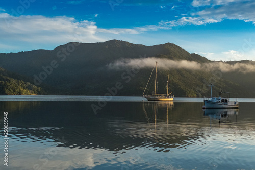 Boats sitting on flat calm waters of the the Marlborough Sound photo