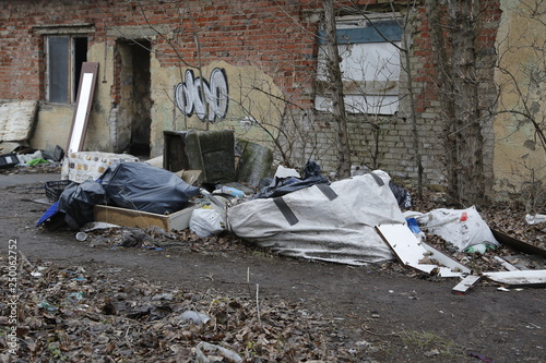 Environmental problems and nature pollution. Waste dumped in the city, an illegal social issue. Rubbish, garbage, outdoor, city, landscape, city space, abandoned area, ruined building