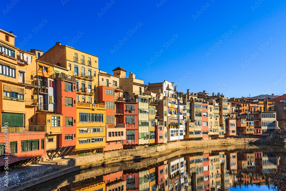Multi-coloured houses along the River Onyar near Gomez brdge in Girona, Spain