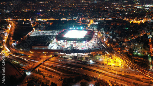 Fototapeta Naklejka Na Ścianę i Meble -  Aerial drone photo of famous illuminated football stadium of Karaiskaki in the heart of Piraeus, Attica, Greece