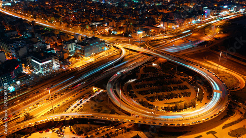 Aerial drone night shot of multilevel junction highway with moderate traffic