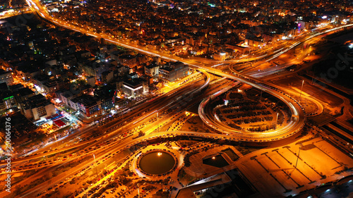 Aerial drone night shot of multilevel junction highway with moderate traffic