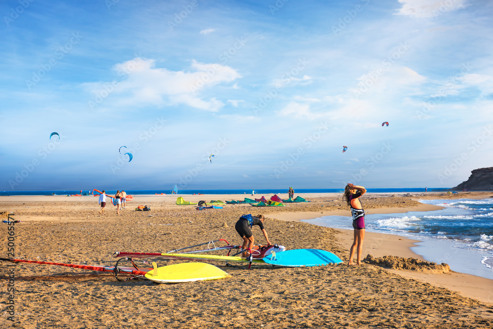 Two girls getting ready to windsurf on Prasonisi beach (Rhodes, Greece) Two girls getting ready to windsurf on Prasonisi beach (Rhodes, Greece)