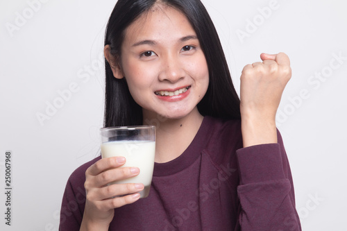 Healthy Asian woman drinking a glass of milk.