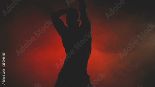 Silhouette of a dancing sexy man