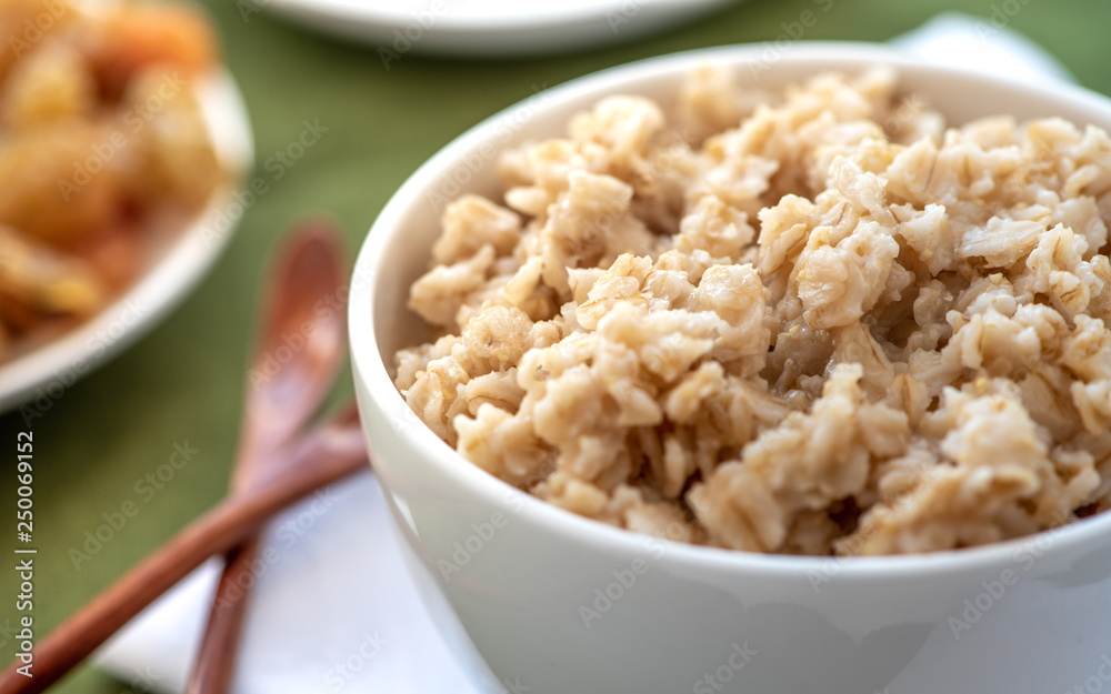 Oatmeal in a white bowl. Healthy breakfast. Oatmeal in a white bowl. Healthy breakfast.