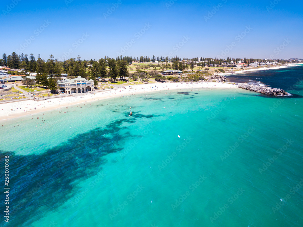 Aerial photograph over a busy Cottesloe Beach, Perth, Western Australia, on a clear summer afternoon.