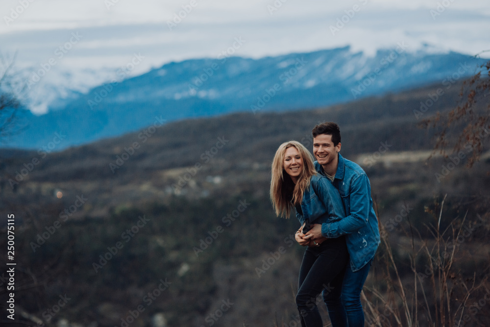 Couple family traveling together on cliff edge. man and woman lifestyle. concept summer vacations outdoor view mountain top. on blue mountains background