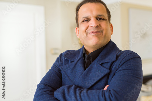 Middle age man smiling confident to the camera at home