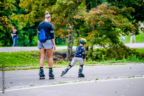 Mom and son roller skating in the Park 