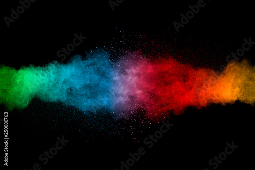 Explosion of multicolored dust on black background.