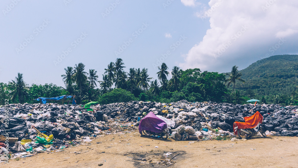 PLASTIC POLLUTION in the jungle. Dirty plastic bottles and bags on a garbage. Ocean pollution, plastic in water. Pollution and recycle eco concept PLASTIC POLLUTION in the jungle. Dirty plastic bottles and bags on a garbage. Ocean pollution, plastic in water. Pollution and recycle eco concept