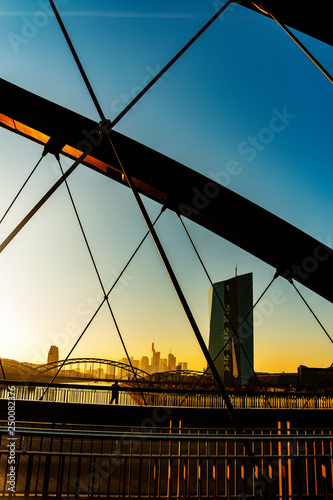 Skyline of Frankfurt at main at sunset behind bridges