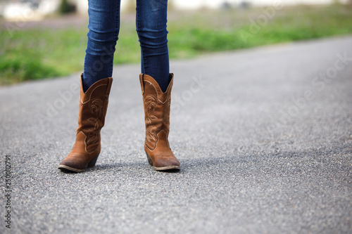 Tween Girl Legs in Cowboy Boots Standing in the Road