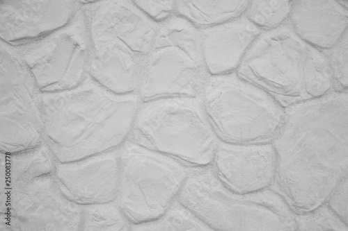 Fragment of a white stone wall. White stones laid in the wall. The texture of the white wall.