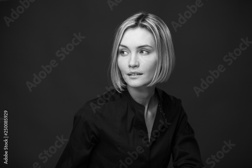 Dramatic black and white portrait of a beautiful woman on a dark background