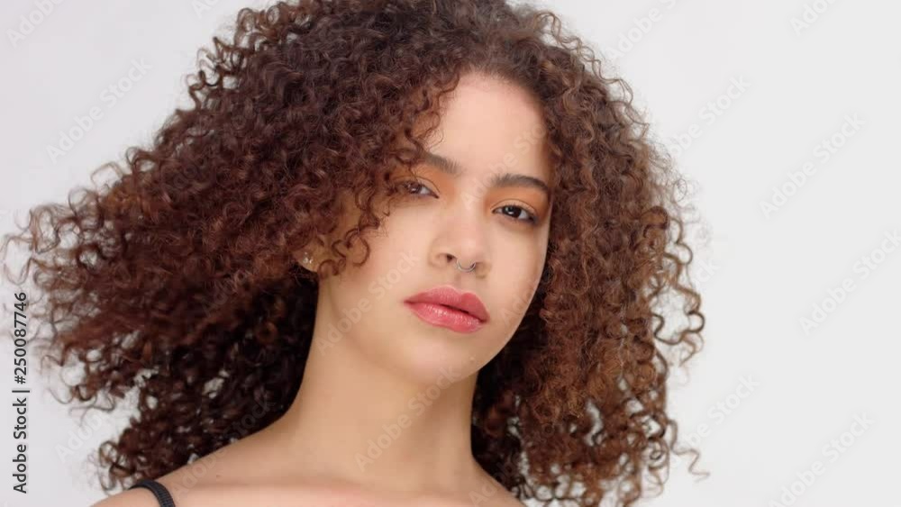 slow motion from 60 fps hair blowing closeup portrait of mixed race model with freckles