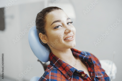 Close up of client smiling while waiting for a stomatologist at dental office.