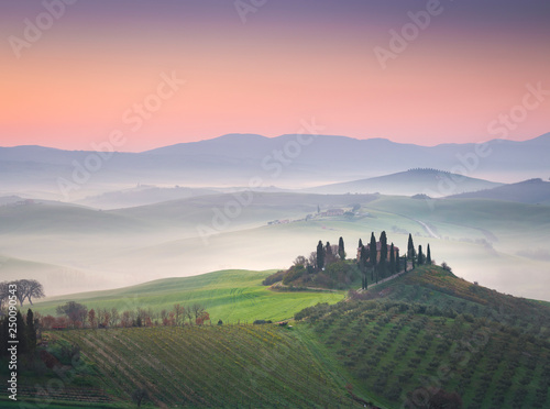 A lonely farmhouse between tuscan rolling hills. Val d'Orcia, Siena province, Tuscany, Italy