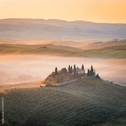 A lonely farmhouse between tuscan rolling hills. Val d Orcia  Siena province  Tuscany  Italy