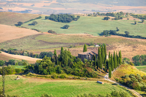 A lonely farmhouse between tuscan rolling hills. Val d'Orcia, Siena province, Tuscany, Italy