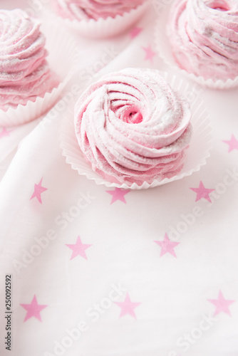 Some pink marshmallow curl on white background
