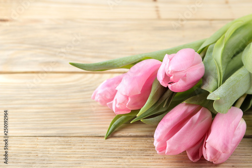Beautiful bouquet of flowers of pink tulips on a natural wooden background. close-up. Spring. holidays.