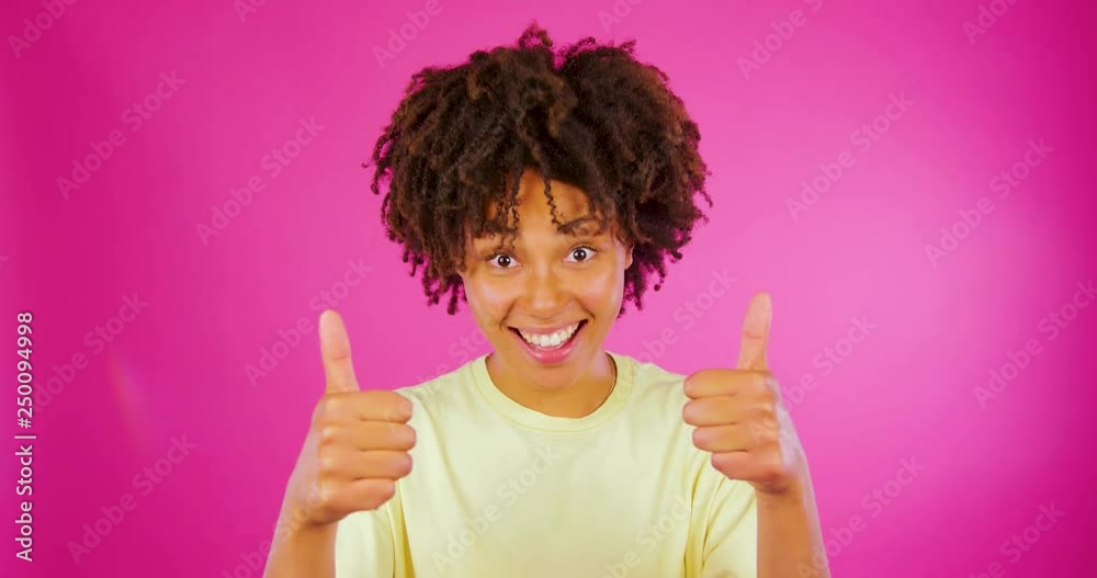 African Girl Gesturing Thumbs Up Isolated On pink Background African Girl Gesturing Thumbs Up Isolated On pink Background