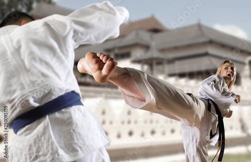 Caucasian female in kimono practicing taekwondo