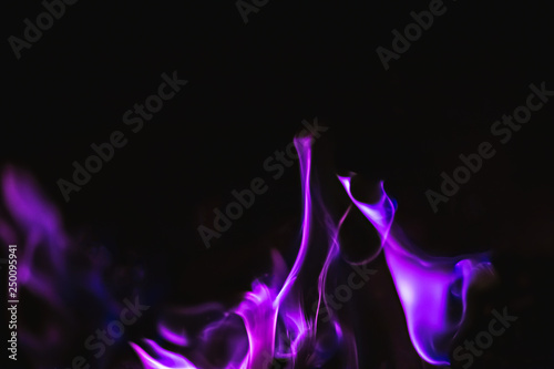 Black background image of purple fire forms