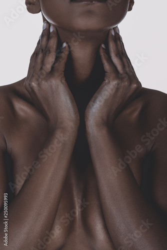 Obraz na płótnie Statuesque cleavage of nude black mixed race woman covering breast
