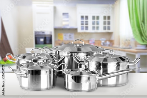 Collection of aluminum pans  on wooden table photo