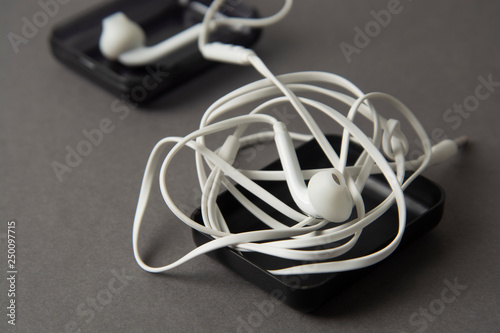 White headphones isolated on grey background. Gadget and accesories.