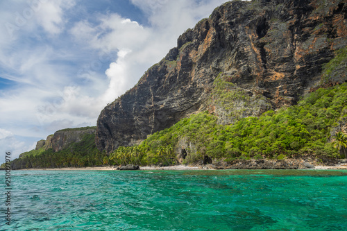 Tropical beach between the rocks. Paradise secluded island. 