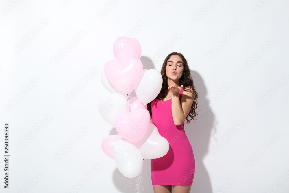 Beautiful girl with heart balloons on white background Beautiful girl with heart balloons on white background