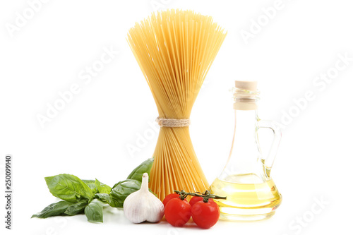 Spaghetti with garlic, tomatoes and basil leafs isolated on white background