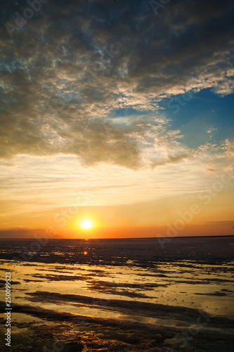 Beautiful natural textural background of the sunset on the lake  river. Salt lake Elton  Russia  sunset on the water