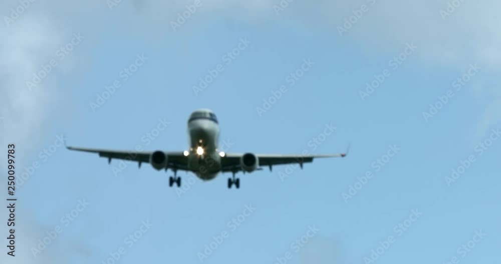 White passenger airplane landing. Plane on blue sky. Background. White passenger airplane landing. Plane on blue sky. Background.