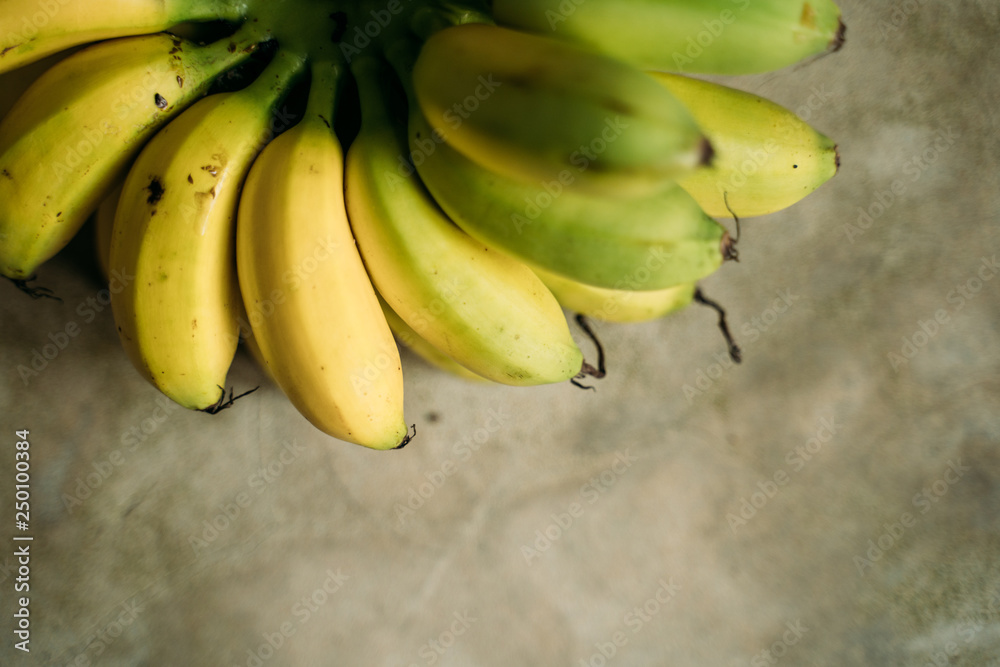 fresh mini bananas on the grey background