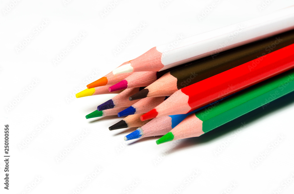 Naklejka premium Colourful sharp pencils lie on a white background