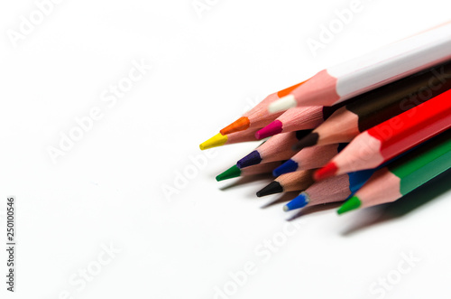 Colourful sharp pencils lie on a white background