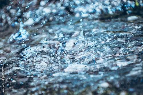 Abstract blurred water splash texture on blue background for freshness concept