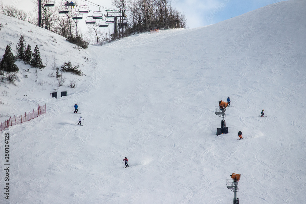 Skiers and Ski Lift on a Ski Run